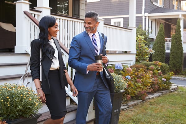 A black couple in office clothes leave for work.